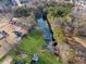 A beautiful aerial view of a home surrounded by lush greenery and a calm lake with a dock at 5422 Hill Sw Rd, Powder Springs, GA 30127