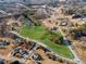 Aerial view shows a large property with greenery, trees, and houses in a residential area at 5422 Hill Sw Rd, Powder Springs, GA 30127