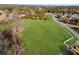 Expansive green lot with mature trees, bordering a road and a white fence in an aerial view at 5422 Hill Sw Rd, Powder Springs, GA 30127
