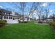 View of the home's back exterior, featuring an expansive yard, lush greenery and covered patio at 5422 Hill Sw Rd, Powder Springs, GA 30127