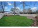 Spacious backyard with a well-maintained lawn and a classic white picket fence at 5422 Hill Sw Rd, Powder Springs, GA 30127