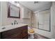 Traditional bathroom featuring a shower, vanity, and mirror with a light and neutral color palette at 5422 Hill Sw Rd, Powder Springs, GA 30127