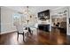 Bright dining room featuring a glass table, modern lighting, and hardwood floors at 5422 Hill Sw Rd, Powder Springs, GA 30127