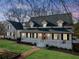 Charming home exterior featuring a welcoming front porch, classic white columns and a well-manicured lawn at 5422 Hill Sw Rd, Powder Springs, GA 30127
