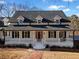 Front view of a two-story white brick home with a large porch at 5422 Hill Sw Rd, Powder Springs, GA 30127