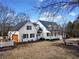 White farmhouse with attached garage, charming porch, and mature trees at 5422 Hill Sw Rd, Powder Springs, GA 30127