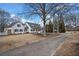 White farmhouse with long driveway, landscaping, and mature trees at 5422 Hill Sw Rd, Powder Springs, GA 30127