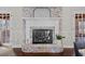 Living room fireplace features a brick surround, white mantle, and black firebox at 5422 Hill Sw Rd, Powder Springs, GA 30127