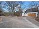 Attached two-car garage with modern wood doors and concrete driveway at 5422 Hill Sw Rd, Powder Springs, GA 30127