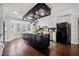 Open-concept kitchen featuring a dark island, butcher block counters and stainless steel appliances at 5422 Hill Sw Rd, Powder Springs, GA 30127