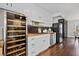 Charming kitchen featuring white cabinets, butcher block counters, black backsplash, and a wine fridge at 5422 Hill Sw Rd, Powder Springs, GA 30127