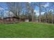 Lush backyard features multiple outdoor buildings, offering plenty of space for relaxation and entertainment at 5422 Hill Sw Rd, Powder Springs, GA 30127