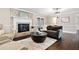 Comfortable living room features a brick fireplace, neutral decor, and hardwood floors at 5422 Hill Sw Rd, Powder Springs, GA 30127