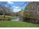 Scenic pond with dock surrounded by geese and lush greenery at 5422 Hill Sw Rd, Powder Springs, GA 30127
