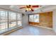 Bright sun room with tile flooring and coffered ceilings, featuring an accent wall with wine crate art at 5422 Hill Sw Rd, Powder Springs, GA 30127