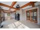 Spacious sunroom with brick accent wall, beamed ceilings, tile floors, and natural light at 5422 Hill Sw Rd, Powder Springs, GA 30127
