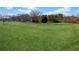 Wide open space with a distant view of the home's architecture and a white picket fence at 5422 Hill Sw Rd, Powder Springs, GA 30127