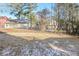 View of a large, partially-fenced backyard with sparse grass and a few trees at 5541 Panola Pl, Lithonia, GA 30058