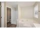 Bright bathroom features a soaking tub with a tiled shower, and modern fixtures at 5541 Panola Pl, Lithonia, GA 30058