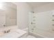 Clean bathroom features a shower-tub combination, sleek fixtures, and storage shelving at 5541 Panola Pl, Lithonia, GA 30058