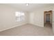 Bedroom features plush carpet, a bright window and fresh neutral paint at 5541 Panola Pl, Lithonia, GA 30058