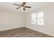 Bedroom with ceiling fan, large window, and vinyl wood flooring at 5541 Panola Pl, Lithonia, GA 30058