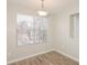 Cozy dining room with window view, modern lighting and wood flooring at 5541 Panola Pl, Lithonia, GA 30058