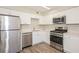 Well-equipped kitchen featuring stainless steel appliances and white cabinetry at 5541 Panola Pl, Lithonia, GA 30058