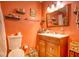 Bathroom with peach walls and a wooden vanity at 981 Meadowbrook Nw Ln, Conyers, GA 30012