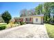 Brick ranch home with a large yard and driveway at 981 Meadowbrook Nw Ln, Conyers, GA 30012