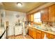 Kitchen features wood cabinets, appliances, and flooring at 981 Meadowbrook Nw Ln, Conyers, GA 30012