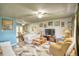 Bright living room with comfy seating and a large TV at 981 Meadowbrook Nw Ln, Conyers, GA 30012