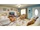 Living room featuring light walls, comfy sofas, and a large TV at 981 Meadowbrook Nw Ln, Conyers, GA 30012