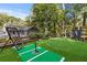 Artificial turf batting cage and tee area in backyard at 1130 Edgewater Dr, Atlanta, GA 30328