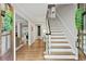 Bright and airy entryway with hardwood floors and elegant staircase at 1130 Edgewater Dr, Atlanta, GA 30328