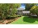 Two-story house with a well-manicured lawn and mature trees at 1130 Edgewater Dr, Atlanta, GA 30328