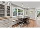 Eat-in kitchen featuring hardwood floors, built-in cabinetry, and a window overlooking the backyard at 1130 Edgewater Dr, Atlanta, GA 30328