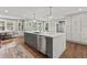 Modern kitchen with large island, stainless steel appliances, and hardwood floors at 1130 Edgewater Dr, Atlanta, GA 30328