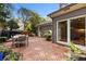 Brick patio with outdoor dining set and lush greenery at 1130 Edgewater Dr, Atlanta, GA 30328