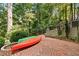 Brick patio with kayaks and lush landscaping at 1130 Edgewater Dr, Atlanta, GA 30328