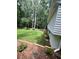 Backyard with wooden retaining wall and lawn at 1221 Martin Nash Sw Rd, Lilburn, GA 30047