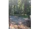 Wooded backyard with a gravel area at 1221 Martin Nash Sw Rd, Lilburn, GA 30047