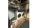 Basement laundry area with washer, dryer, and storage shelving at 1221 Martin Nash Sw Rd, Lilburn, GA 30047