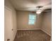 Bright bedroom with grey carpet and ceiling fan at 1221 Martin Nash Sw Rd, Lilburn, GA 30047