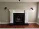 Elegant fireplace with white mantel and black granite hearth at 1221 Martin Nash Sw Rd, Lilburn, GA 30047