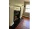 Fireplace with white mantel and black granite hearth at 1221 Martin Nash Sw Rd, Lilburn, GA 30047