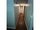 Long hallway with hardwood floors and neutral walls at 1221 Martin Nash Sw Rd, Lilburn, GA 30047