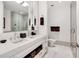 Modern bathroom with double vanity, glass shower, and white tile at 1820 Peachtree Nw St # 607, Atlanta, GA 30309