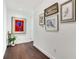 Bright hallway with dark hardwood floors and artwork at 1820 Peachtree Nw St # 607, Atlanta, GA 30309