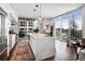 Modern kitchen with white cabinets, marble island, and hardwood floors at 1820 Peachtree Nw St # 607, Atlanta, GA 30309